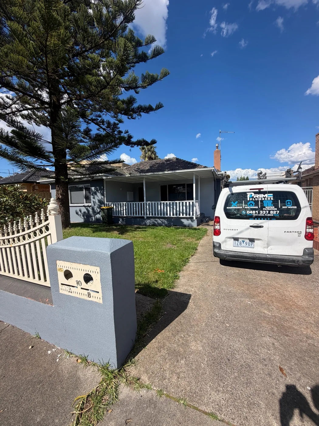 Prime Plumbers Group branded van parked at a residential property