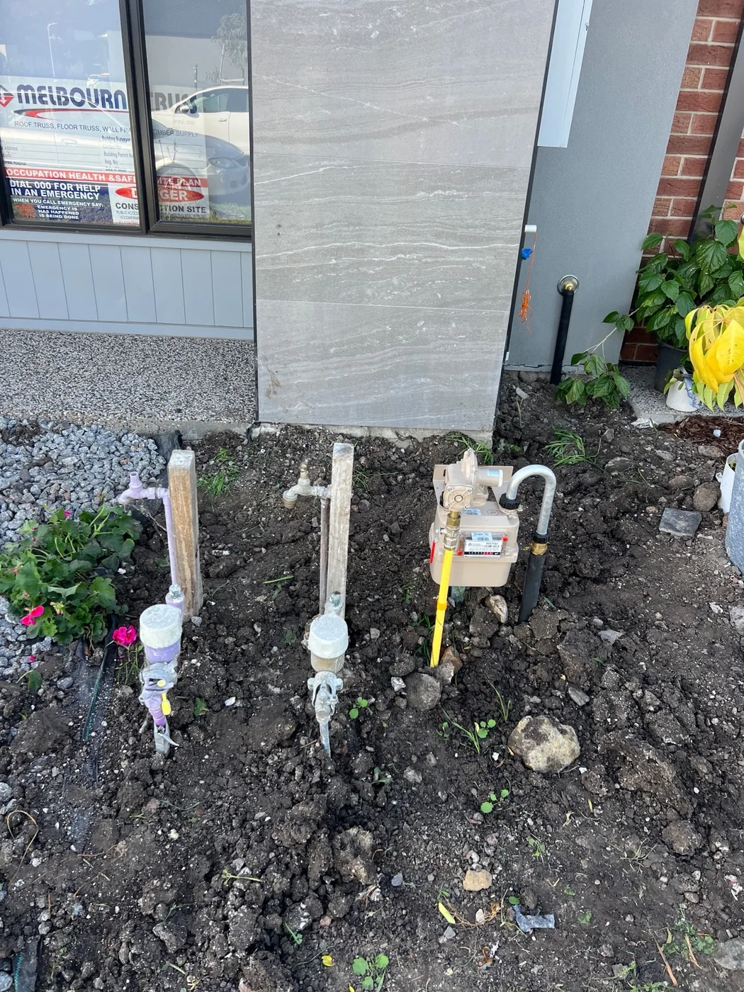Gas meter and water connections outside a home